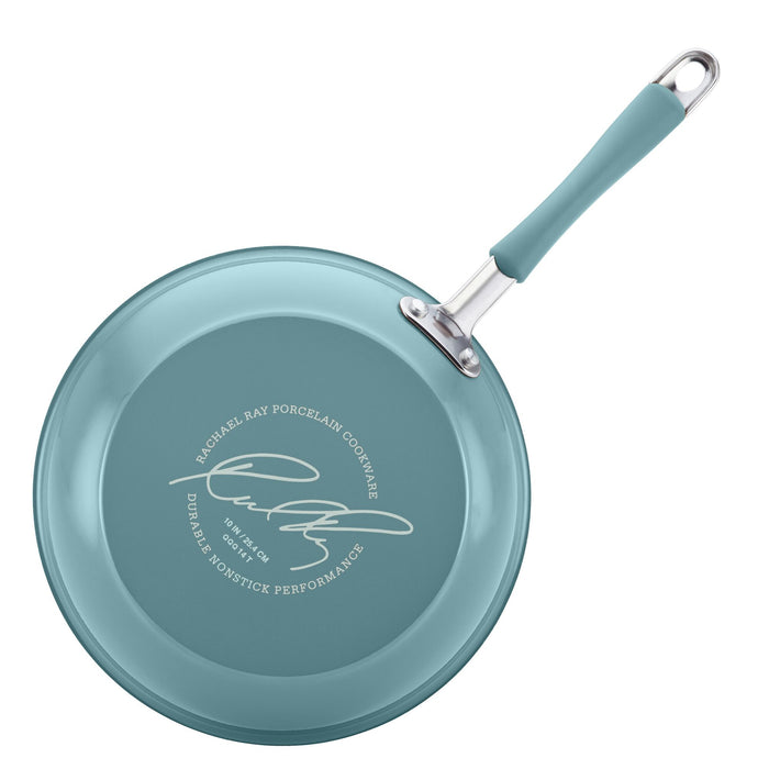 The 18-Piece Cucina Nonstick Cookware and Prep Bowl Set includes a turquoise frying pan crafted from high-performance aluminum with a branded signature on the bottom, ensuring effortless cooking and easy cleanup.