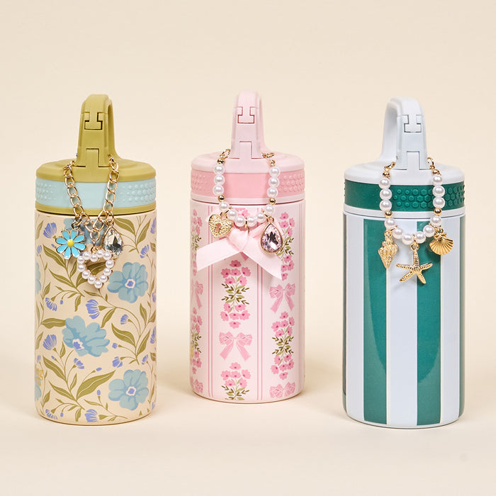 Three tumblers by The Darling Effect feature floral, bow, and striped pastel designs with decorative lids and handlesβperfect for displaying your Simply Coquette Tumbler Charm or favorite drinkware accessories.