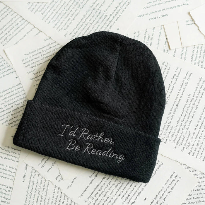 Black beanie with 'I'd Rather Be Reading' text on a paper background