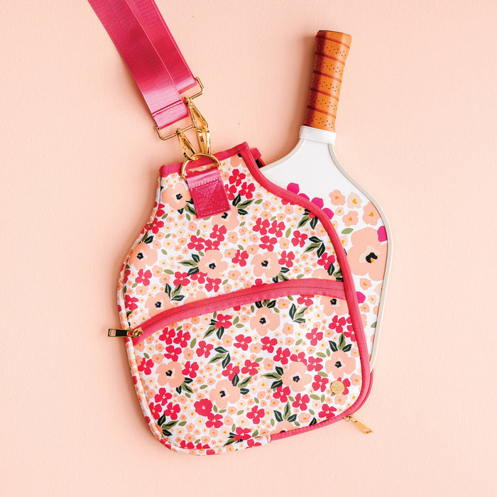 The Darling Effect Lively Flora Pickleball Case with floral pattern and pink strap, shown on a peach background.