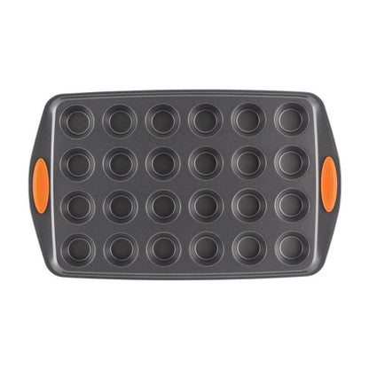 24-Cup Nonstick Mini Muffin Pan featuring orange side grips, designed to be oven safe for all your baking needs.