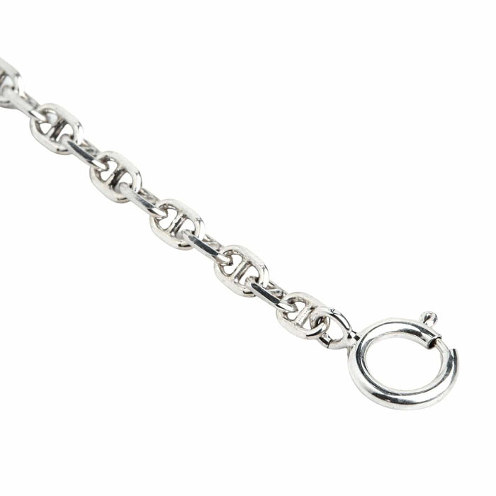 A delicate 2mm silver chain designed in a classic anchor link style, coiled on a clean white background.