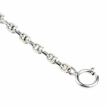 A delicate 2mm silver chain designed in a classic anchor link style, coiled on a clean white background.