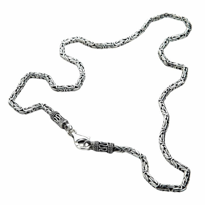 Close-up of Byzantine weave necklace showing ornate lobster clasp and decorative end caps