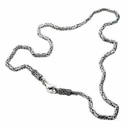 Close-up of Byzantine weave necklace showing ornate lobster clasp and decorative end caps