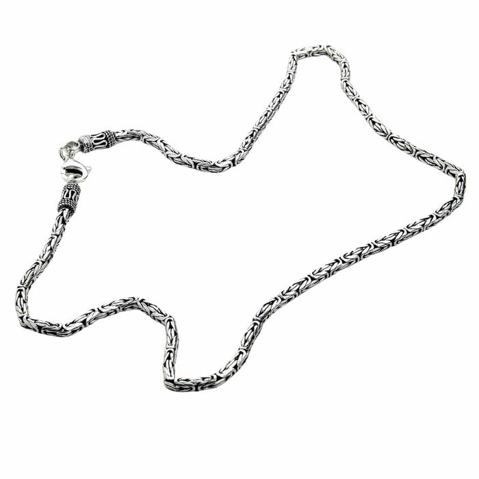 Oxidized sterling silver Byzantine chain laid flat showing rope-like texture and polished links