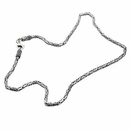 Oxidized sterling silver Byzantine chain laid flat showing rope-like texture and polished links