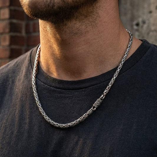 Close-up of a man wearing a 4mm thick Byzantine chain necklace with a 20-inch length, showcasing urban style jewelry fashion.