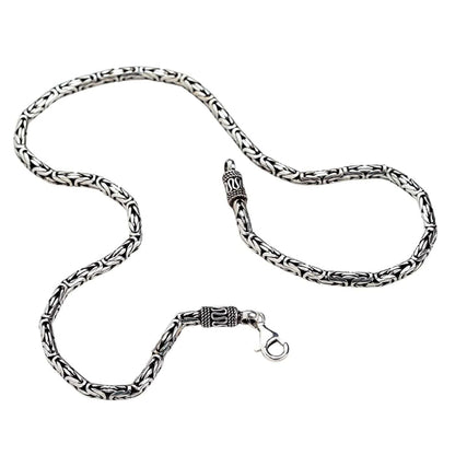 A men's 4mm Byzantine chain in an oxidized, decorative style, showing its intricate, rope-like texture.