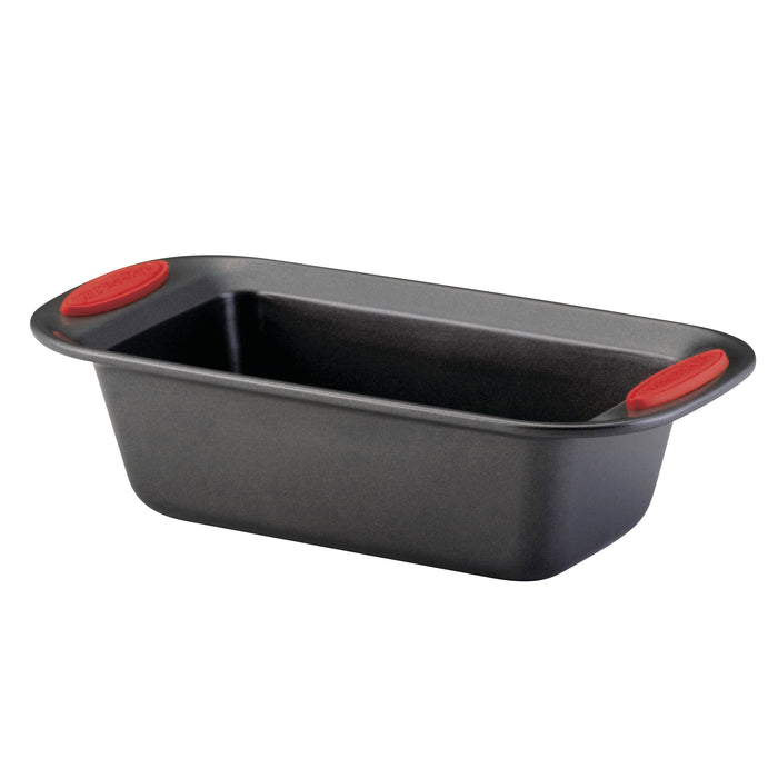 A 9-inch x 5-inch nonstick loaf pan with red handles, made from heavy gauge steel, is set against a white background, ensuring oven-safe durability for all your baking needs.