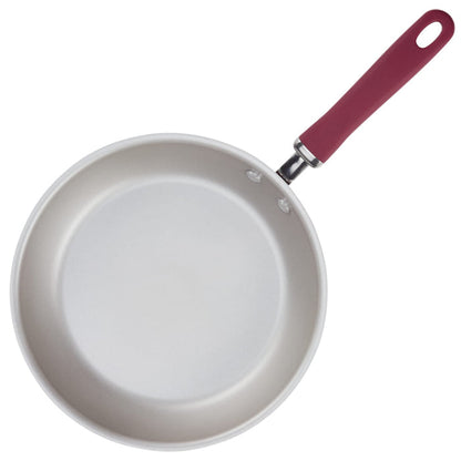 9.5" and 11.75" nonstick frying pan with red handle, viewed from above.