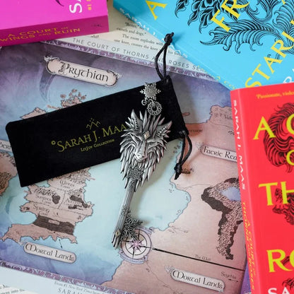ACOTAR Winter Court Key from LitJoy Winter Romantasy TBR Box — ornate silver key with wolf head topper on Sarah J. Maas LitJoy Collection pouch, displayed on Prythian map with ACOTAR series books