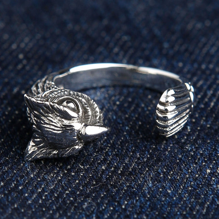 925 sterling silver owl ring front view displaying intricate owl face and tail feather details on blue denim