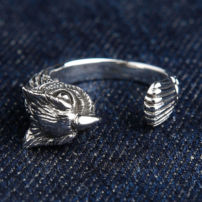 925 sterling silver owl ring front view displaying intricate owl face and tail feather details on blue denim