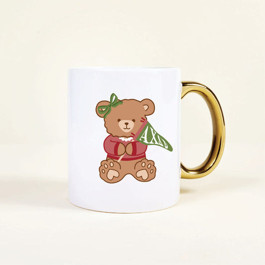 The Darling Effect’s Alpha Chi Omega 11 oz Cozy Cute Ceramic Mug showcases a charming bear in a red sweater with sorority details, making it the perfect gift for any AXiD sister.