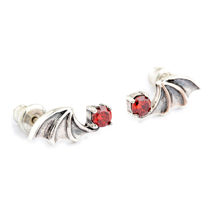 Angled view of both bat earrings showing the four-prong basket that holds each red cubic zirconia