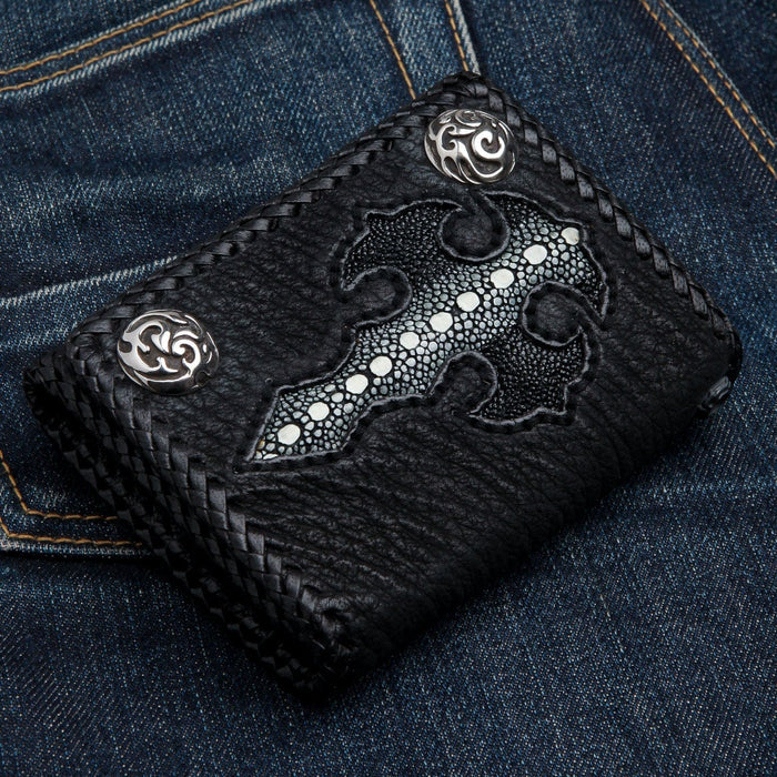 Black stingray gothic cross biker wallet resting in a denim back pocket, silver concho snaps and braided cowhide edges