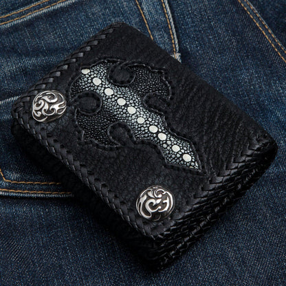 Front of the stingray cross wallet shown upright on blue jeans, two ornate sterling silver snaps at opposite corners