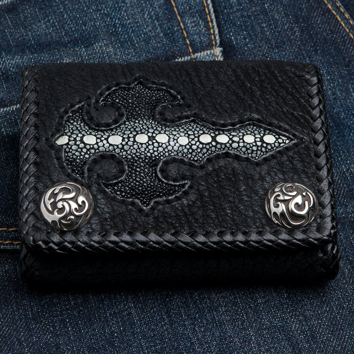 Horizontal close-up of the stingray gothic cross and braided leather border with round silver concho snaps