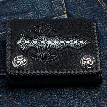 Horizontal close-up of the stingray gothic cross and braided leather border with round silver concho snaps