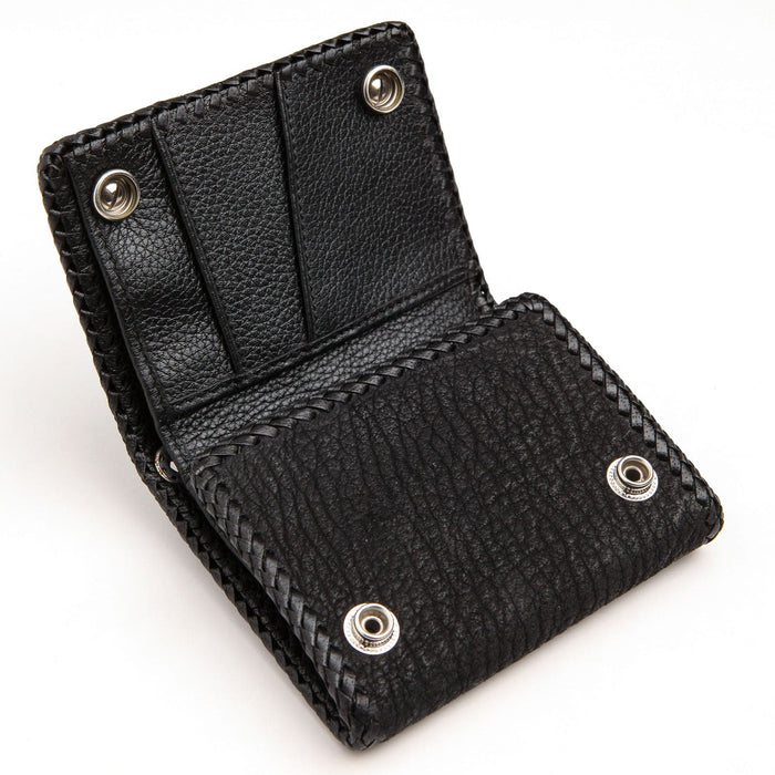 Open interior in black cowhide showing stacked card slots and sterling silver snaps against the textured flap