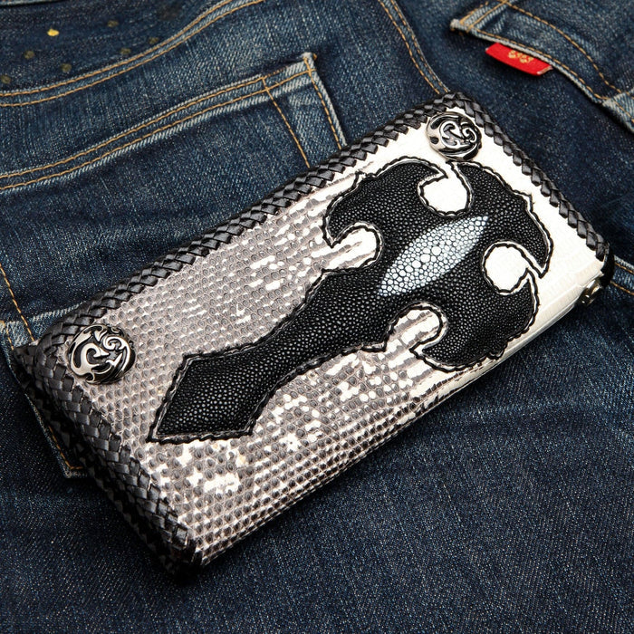 A side view of the handcrafted men's long wallet, showing the black stingray inlay and silver snaps on a denim background.