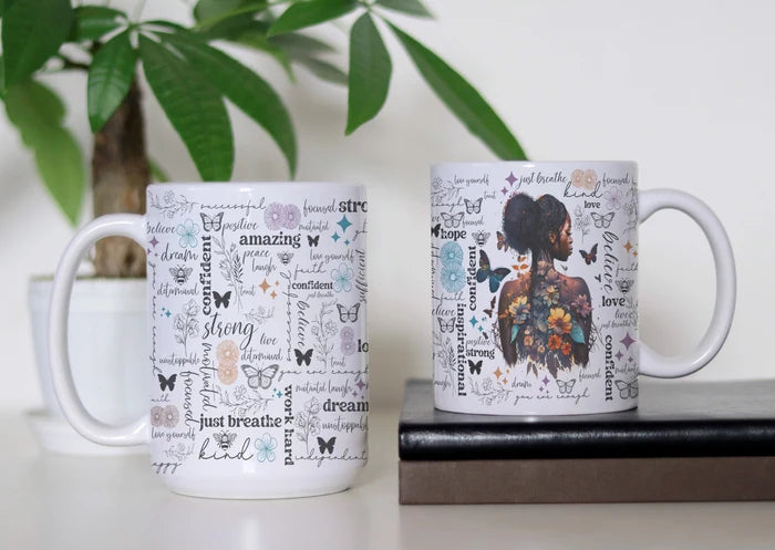 Bloom, Believe & Become white ceramic coffee mug featuring a floral woman, colorful butterflies and positive affirmations including strong, confident, dream, hope, kind and just breathe, available in 11 oz and 15 oz sizes.