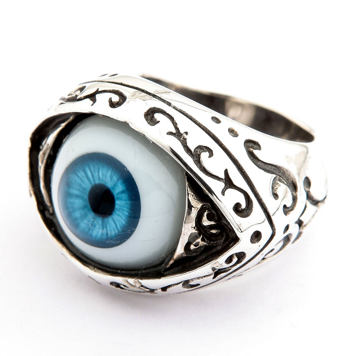 Three-quarter angle of the blue evil eye ring showing Victorian scrollwork running down the silver shoulder