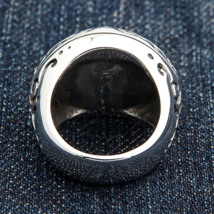 Back view of the silver eye ring revealing the hollow band interior and the polished domed underside of the bezel