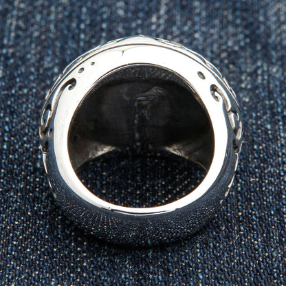 Back view of the silver eye ring revealing the hollow band interior and the polished domed underside of the bezel