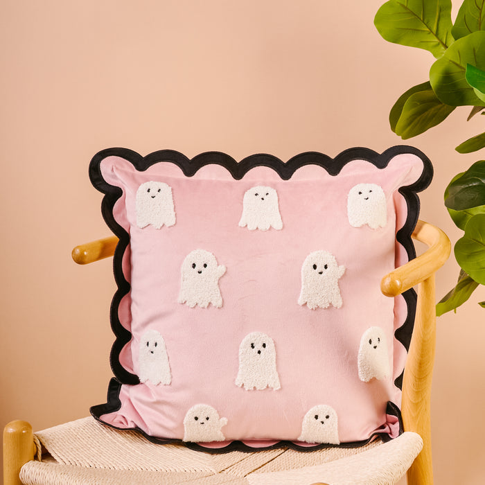 The Boo Crew Scalloped Square Throw Pillow by The Darling Effect features pink fabric, black scalloped edges, and embroidered cartoon ghosts—perfect for layering with other sofa pillows.