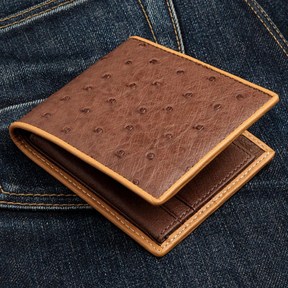 A handcrafted bifold wallet made from genuine ostrich skin with a contrasting tan trim.