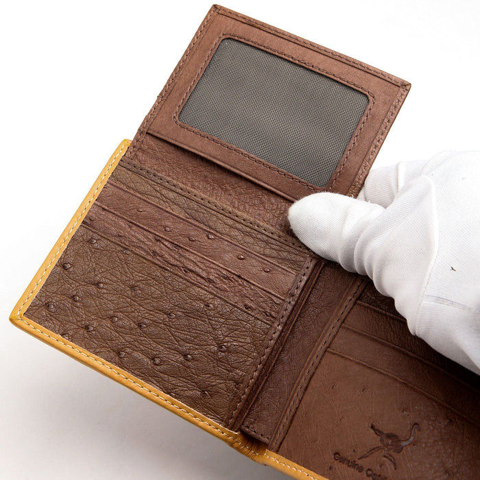 A luxury men's ostrich wallet shown fully open with its flip-up ID window visible.