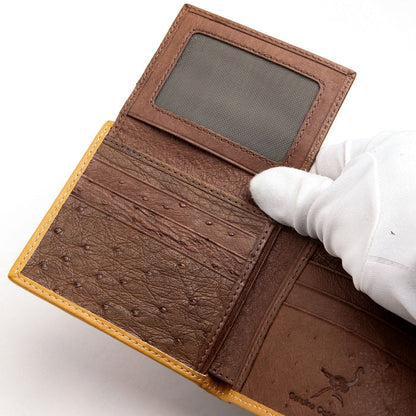 A luxury men's ostrich wallet shown fully open with its flip-up ID window visible.