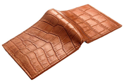 Opened flat with the crocodile exterior facing up, showing both belly panels and the raised fold at the spine.