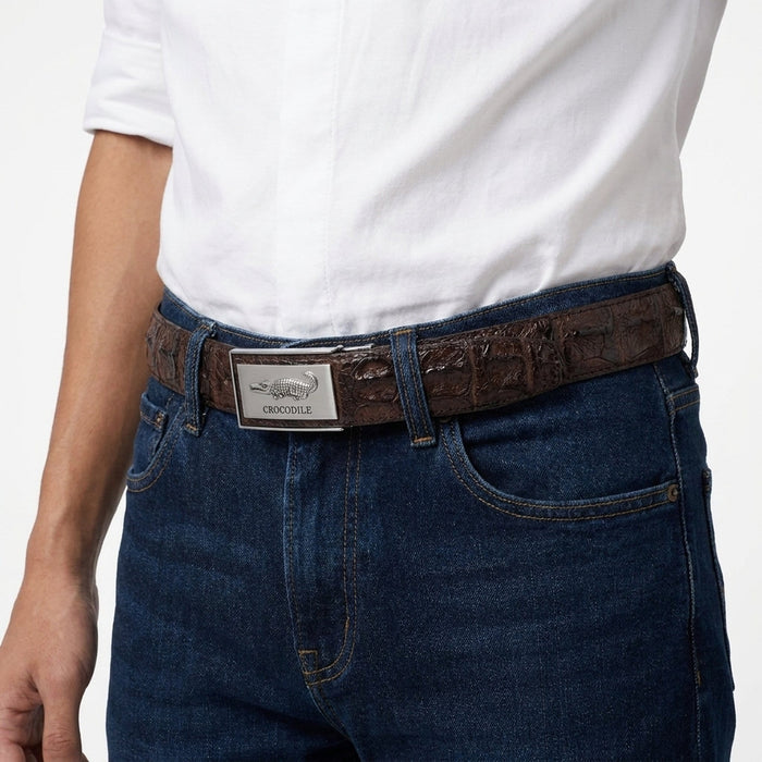 Close-up waist shot of a male model wearing dark brown hornback crocodile belt with silver auto-lock buckle