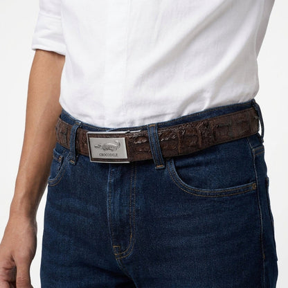 Close-up waist shot of a male model wearing dark brown hornback crocodile belt with silver auto-lock buckle