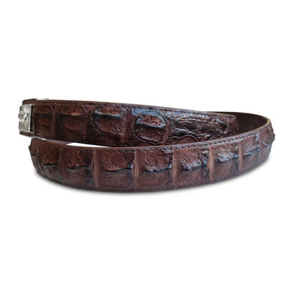 Macro detail of raised hornback scales on dark brown crocodile leather belt — the dorsal ridge texture
