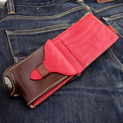 Open interior view of a dark brown biker wallet on denim, red pebbled card-slot wing extending upper-right.