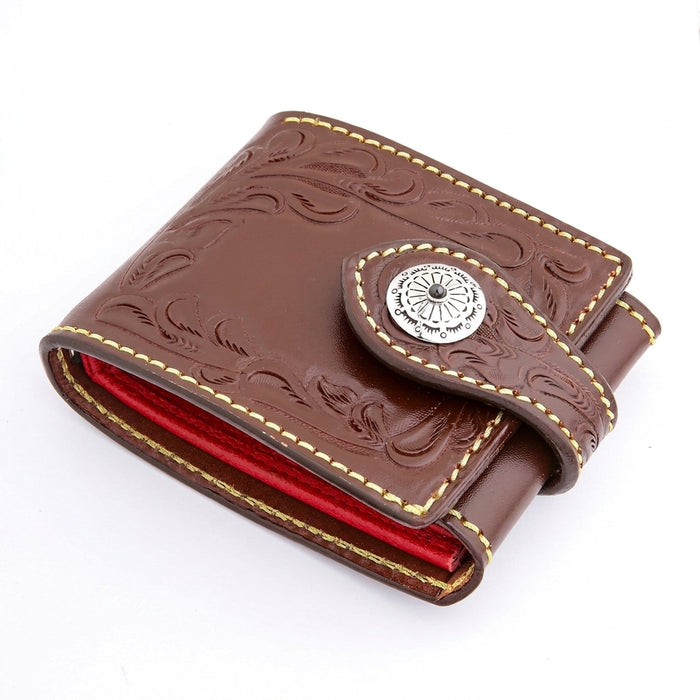 Hero three-quarter angle of a dark brown hand-tooled biker wallet with Western florals and a sterling silver concho.