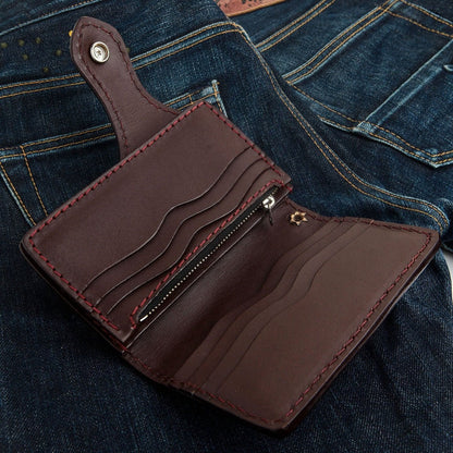Open interior of the dark brown cowhide wallet revealing multiple wavy card slots, a zipper compartment, and red stitching.