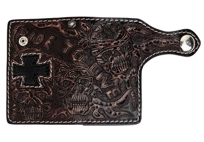 Unfolded flat view showcasing the complete hand-tooled skull and flames design with lizard cross inlay on dark cowhide.
