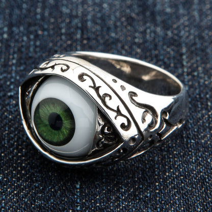 Three-quarter angle of the eyeball ring revealing filigree scrollwork running down the shoulder of the silver band