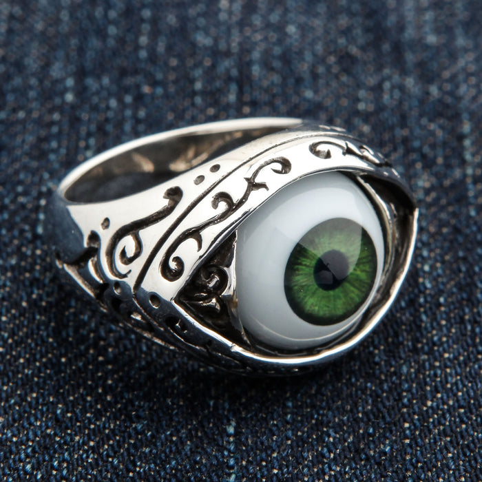 Top-down macro of the dark green iris and pupil framed inside the almond eye-shaped bezel of the ring