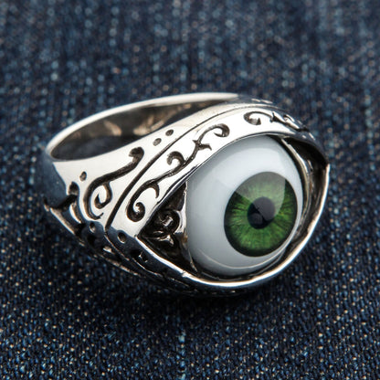 Top-down macro of the dark green iris and pupil framed inside the almond eye-shaped bezel of the ring