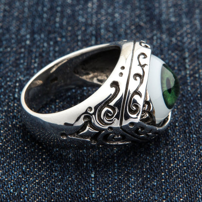 Side profile of the gothic eyeball ring showing band depth, scrolled shoulder filigree and oxidized recess shadows