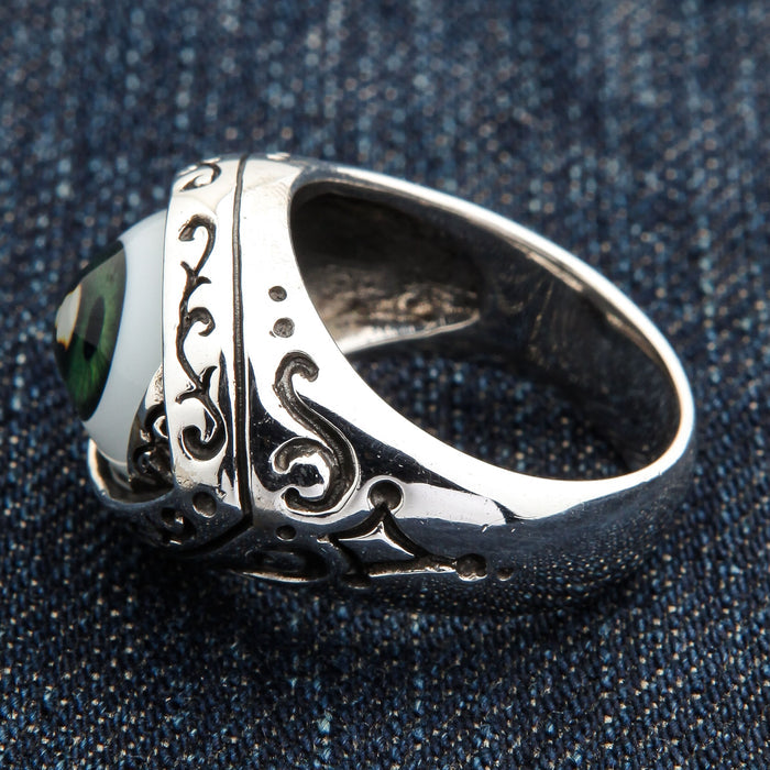 Interior angle showing the band's open recess and filigree shoulder of the dark green eyeball ring