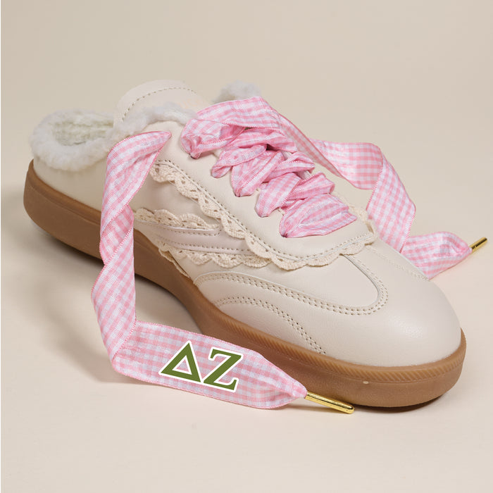 The Darling Effect’s Delta Zeta Step It Up Shoelaces feature pink gingham laces with green Delta Zeta Greek letters on the lace tips—perfect for gifting and sorority style.