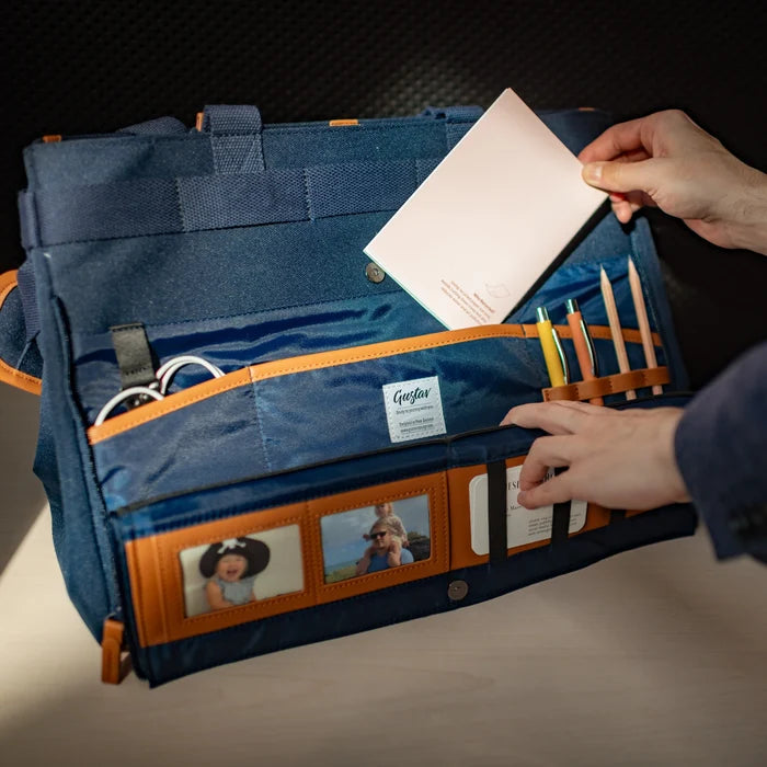 DeskMate navy blue work bag unfolded into desk organizer – shared workspace setup