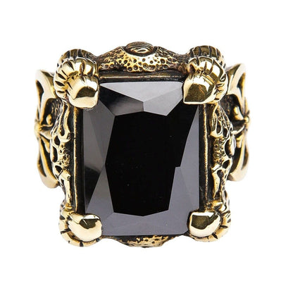 A gothic dragon ring with a huge black onyx stone, featuring intricate scale details and a mysterious side emblem.